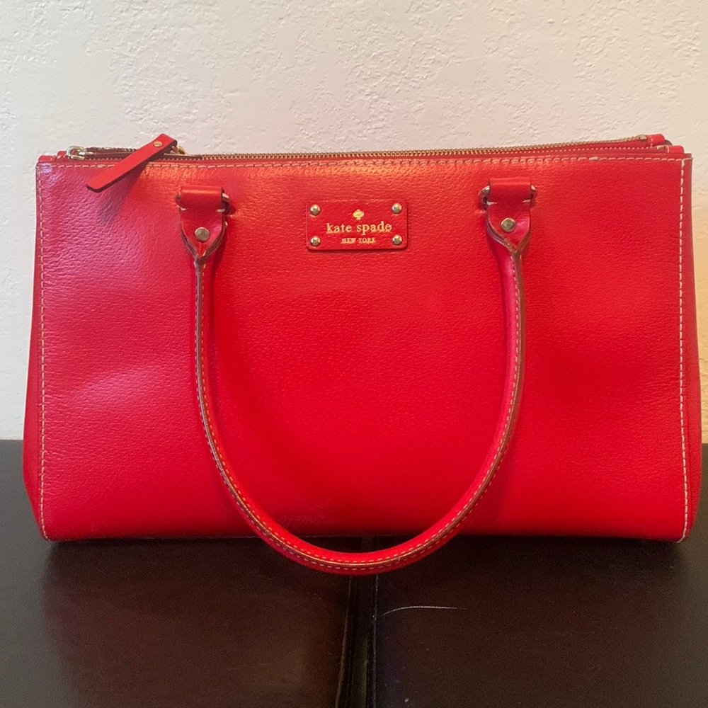 Kate Spade Red Purse.Three compartments, two zippered, middle is a snap